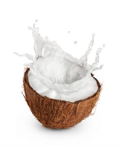 A split open coconut half with juice splashing out. Coconut water can be used to make your weed taste better.